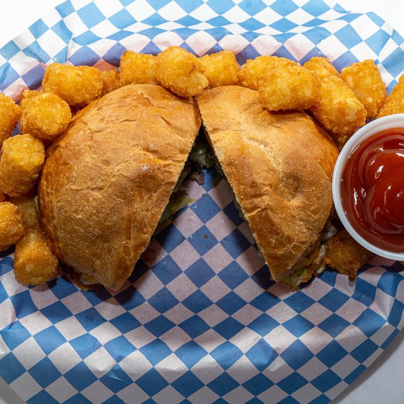 Burger with tots and red salsa